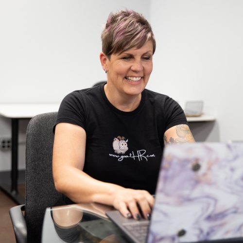 Woman working on her laptop and smiling